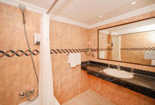 a bathroom with a shower and a sink at El Andalous Lounge & Spa Hotel in Marrakesh