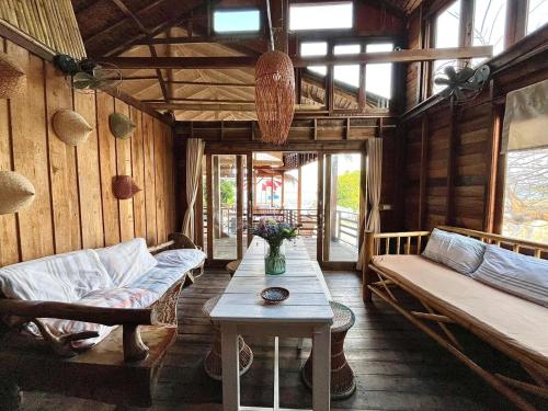 a living room with a couch and a table at Lipe BeachHouse in Ko Lipe