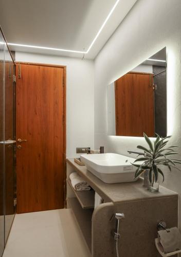 a bathroom with a sink and a mirror at LohonoStays Villa Lani in Alībāg