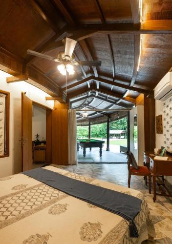 a bedroom with a bed and a pool table at LohonoStays Villa Lani in Alībāg