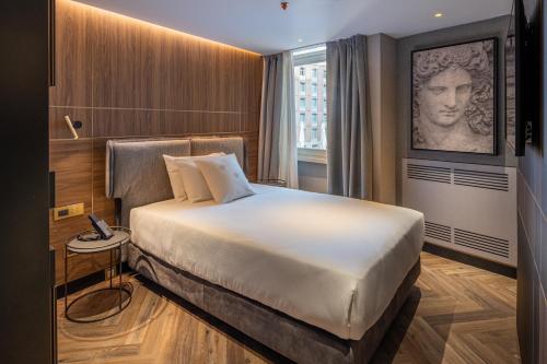 a hotel room with a large bed and a window at Palazzo 4 Fontane 12 in Rome