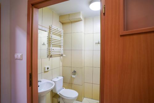 a bathroom with a toilet and a sink at Hotel Stadion in Kielce