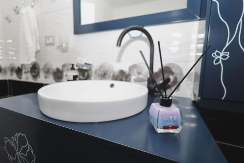 a bathroom with a white sink and aaucet at Greis Home in Maliq