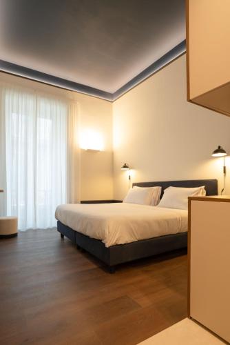 a bedroom with a bed and a large window at Maison Petronilla in Naples