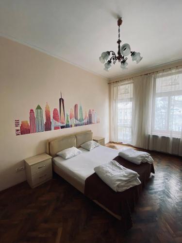 a bedroom with a bed and a chandelier at New York Hostel in Lviv