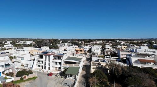 an aerial view of a city with white buildings at Attico Fronte Mare Salento in Torre San Giovanni Ugento