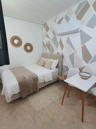 a bedroom with a bed and a table and a tv at Galatia Studio in Thérissos