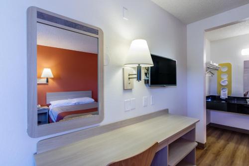 a mirror in a hotel room with a bed at Motel 6 Modesto, CA in Modesto