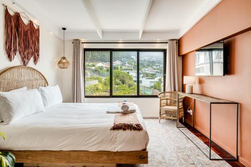 a bedroom with a bed and a large window at Song of Ascent in Cape Town
