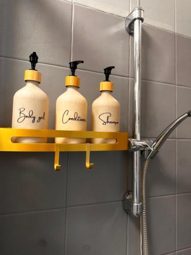 four bottles of soap on a shelf in a bathroom at Elite in Rovigo