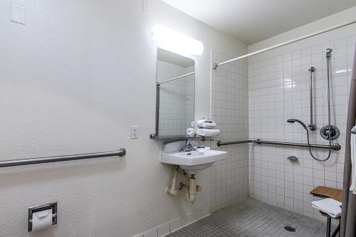a bathroom with a sink and a mirror at Motel 6 Modesto, CA in Modesto