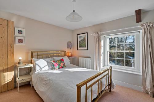a bedroom with a bed and a window at Finest Retreats - Meadowsweet Cottage in Wingfield