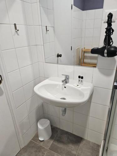 a white bathroom with a sink and a mirror at Sleep and Go in Santana in Nature B&B in Santana