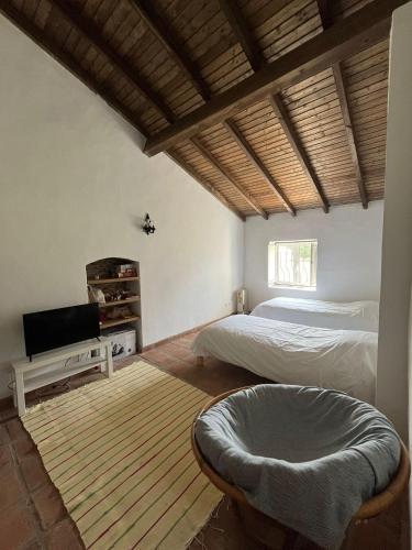 a bedroom with a bed and a tv in it at Monte do Vale in Casa Branca