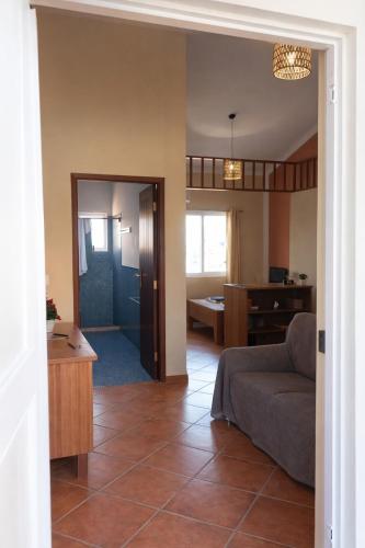a living room with a couch and a dining room at Maio Sweet Tartaruga in Vila do Porto