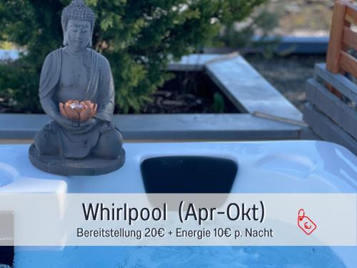 a statue of a buddha holding a bowl of fruit at SONNENTERRASSE - 3 Schlafzimmer, Whirlpool & Alpenblick - Perfekt für Romantik oder Familienurlaub mit Kind , Hund willkommen by FerienWohnenAmSee - in Überlingen