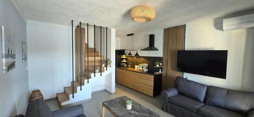 a living room with a couch and a tv at Villa Ružmarin in Lovište
