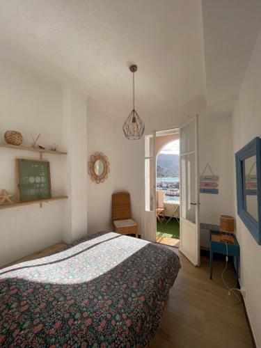 a bedroom with a bed and an open door at Vue de rêve in Cassis