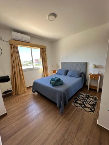 a bedroom with a bed and a large window at Dpto 15 - Colon - 2 DORMITORIOS - PQ ALQUILERES TEMPORARIOS in Colón