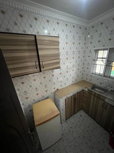 a small kitchen with a sink and a refrigerator at Funkytee Apartments in Isasi