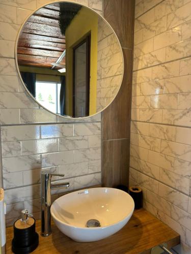 a bathroom with a white sink and a mirror at Ecolodge in Potrero de Garay