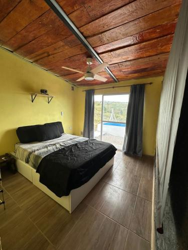 a bedroom with a bed with a wooden ceiling at Ecolodge in Potrero de Garay