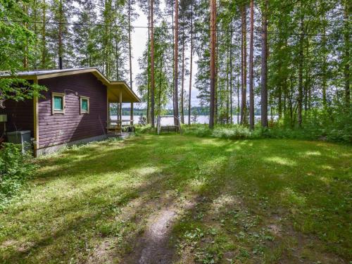 a house in the middle of a yard with trees at Holiday Home Leppäranta by Interhome in Harjula