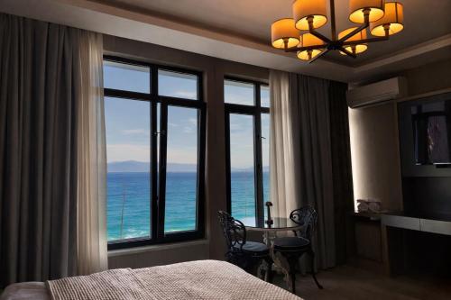 a bedroom with a room with a view of the ocean at Yalı Bahçe Mudanya in Burgaz