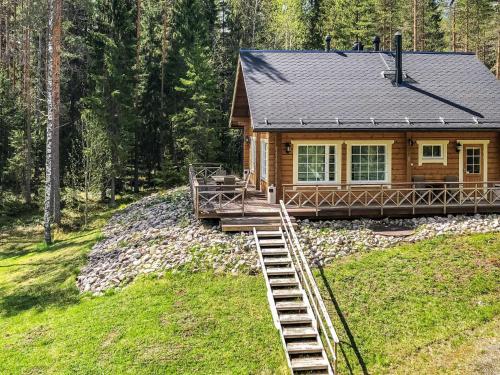 a log cabin with a staircase leading up to it at Holiday Home Inkeri by Interhome in Holiseva
