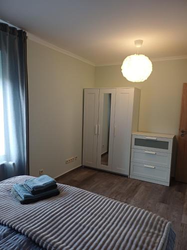a bedroom with a bed and a dresser and a mirror at FeWo Sasa in Blankenburg