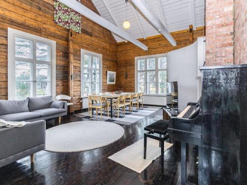 a living room with a piano and a table at Holiday Home Säikkäranta by Interhome in Oulunsalo