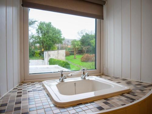 a large white sink in a room with a window at Orchard House - Dingle Town Centre in Dingle