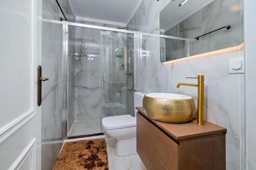 a bathroom with a sink and a shower and a toilet at Theodoros Kolokotronis in Nafplio