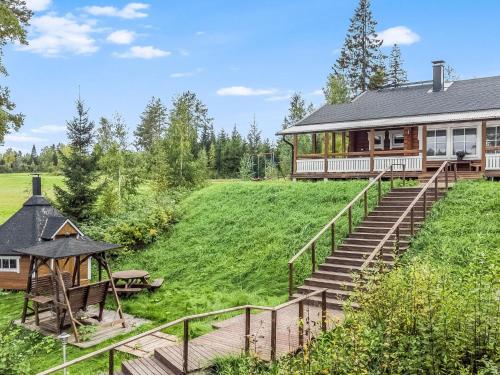 a house with stairs leading up to a house at Holiday Home Kaislaranta by Interhome in Lahdenkylä