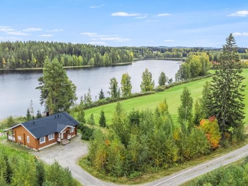 an aerial view of a house next to a lake at Holiday Home Kaislaranta by Interhome in Lahdenkylä