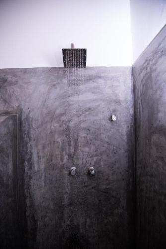 a close up of a metal wall with a door at LEONS Stay in Galle