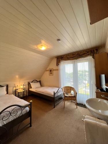 a bathroom with two beds and a sink in a room at Aparts4ring 5 Nürburg in Nürburg