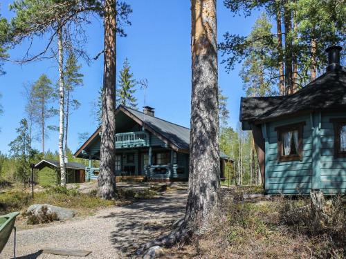 a house in the woods with trees at Holiday Home Marjaranta by Interhome in Konnevesi