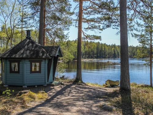 a small house on the shore of a lake at Holiday Home Marjaranta by Interhome in Konnevesi