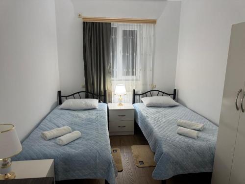 a room with two beds and a window at NAPO HOTEL სასტუმრო ნაპო in Zugdidi