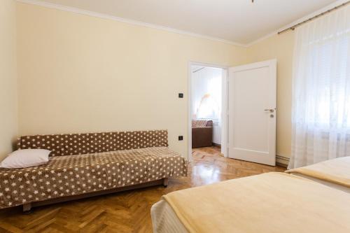 a room with two beds and a couch in it at Apartment Marija in Zagreb