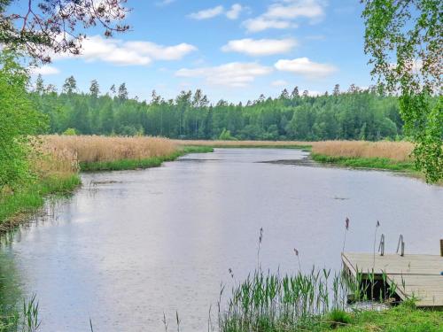 a river with a boat in the middle at Holiday Home Annas beach by Interhome in Haminankylä