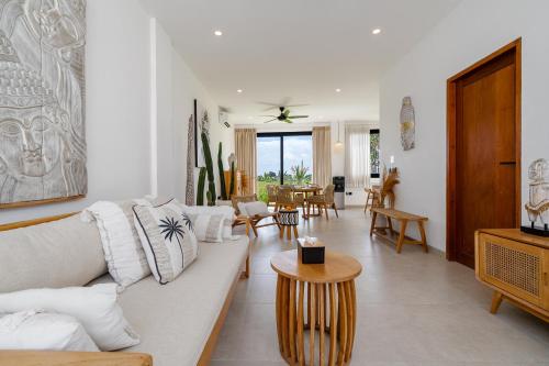 a living room with a couch and a table at Villa Sawahku - 2BR Private Villa with Rooftop & Rice Field View in Canggu