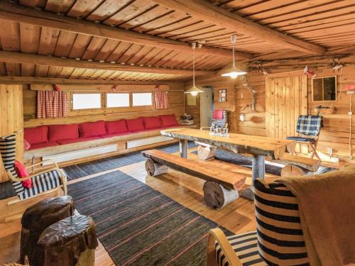 a living room with a red couch and a table at Holiday Home Miilumaja by Interhome in Äkäslompolo