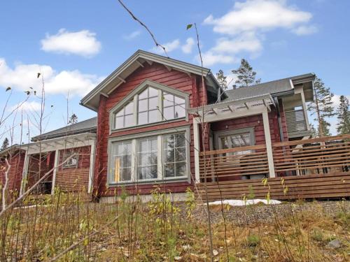 a home with a red house at Holiday Home Sopukka by Interhome in Vuokatti