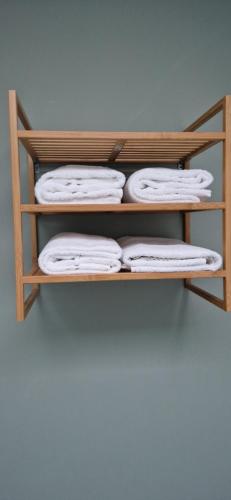 a wooden shelf with white towels on it at Oar restaurant and Rooms in Doolin