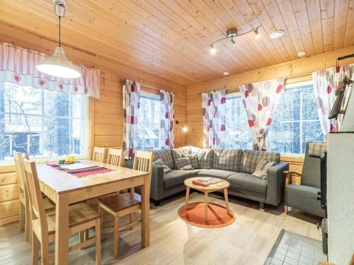 a living room with a couch and a table at Holiday Home Simeoni by Interhome in Äkäslompolo