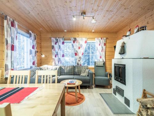 a living room with a couch and a fireplace at Holiday Home Simeoni by Interhome in Äkäslompolo