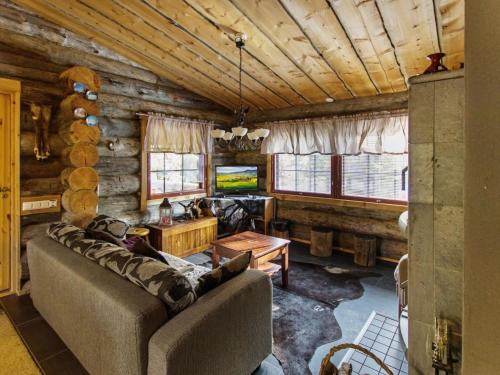 a living room with a couch and a tv at Holiday Home Äkäsranta by Interhome in Äkäsjoensuu