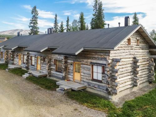 a log cabin with a black roof at Holiday Home Sapara c10 by Interhome in Äkäslompolo
